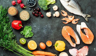 Jar of marine collagen powder with fresh citrus and fish, highlighting its natural source and benefits for skin, joints, and overall vitality.